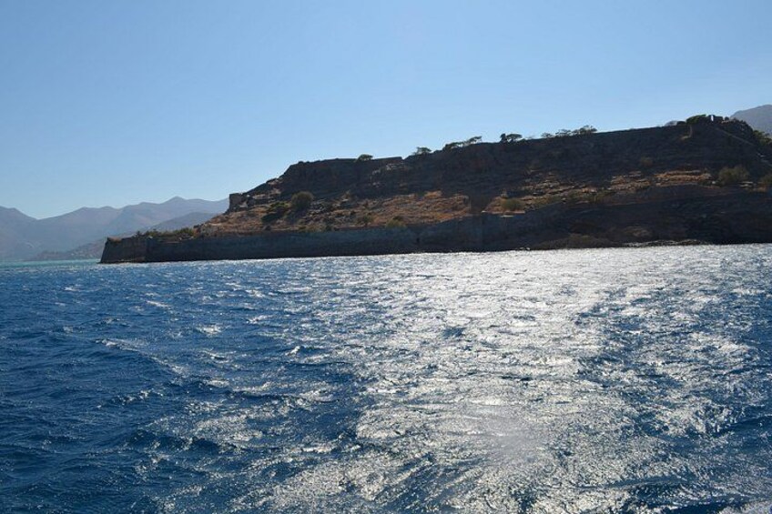 A coastal landscape with a rocky cliff and calm sea. 3