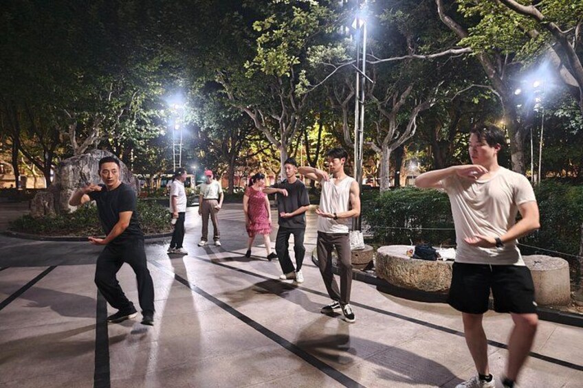 People exercising in an outdoor park at night. 2