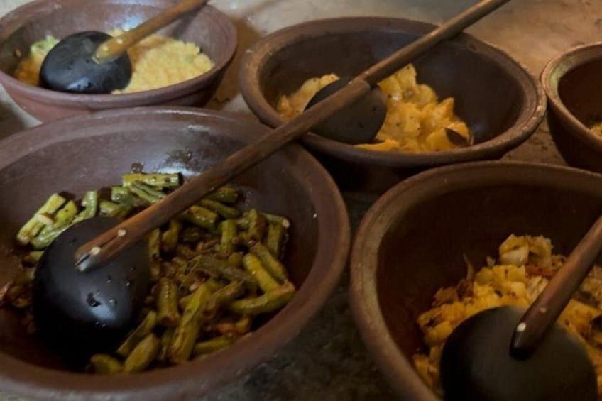 Several clay bowls with food and utensils. 2