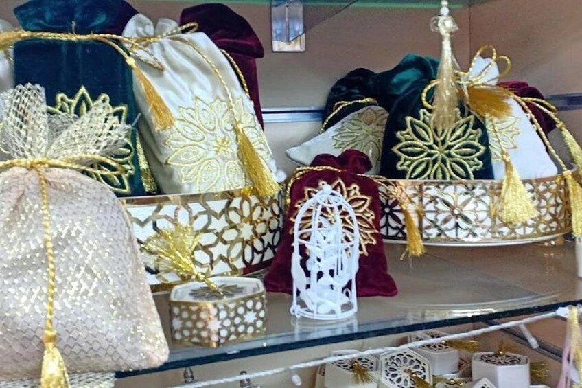 A display of decorative pillows and cushions with gold embroidery and tassels. 3