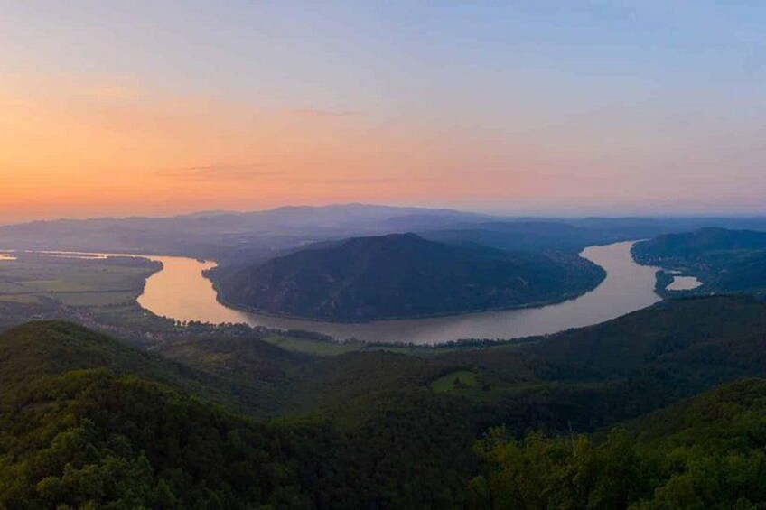 A river winding through a valley with hills on either side. 4