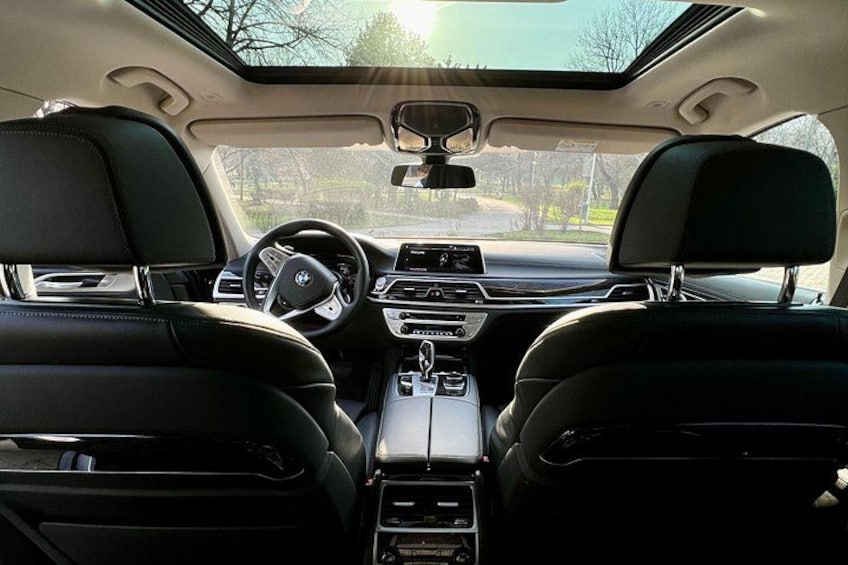 L'intérieur d'une voiture, avec un toit ouvrant, des sièges en cuir, un volant et un tableau de bord. 3