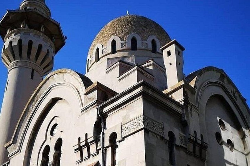 A mosque with a large dome and minarets. 3