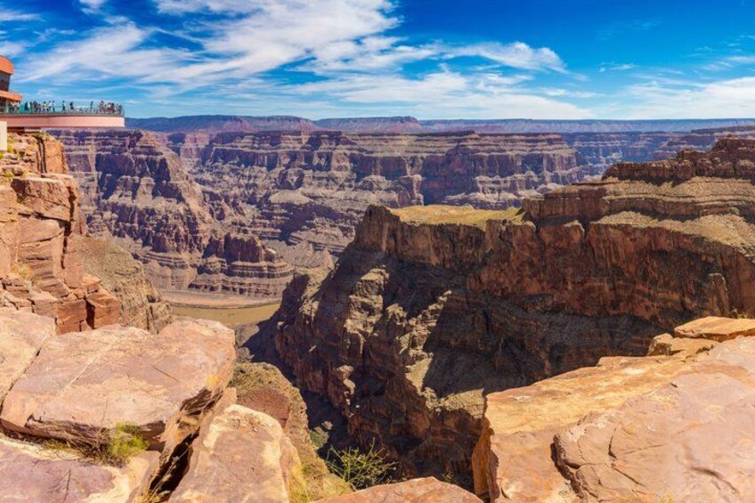 A canyon with layered rock formations and a viewpoint overlooking the landscape. 5