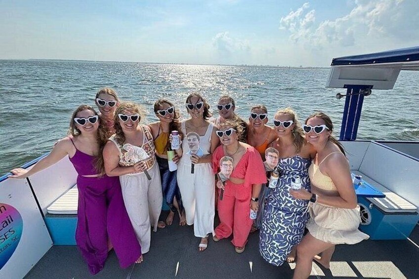 A group of people on a boat with a body of water in the background. 4
