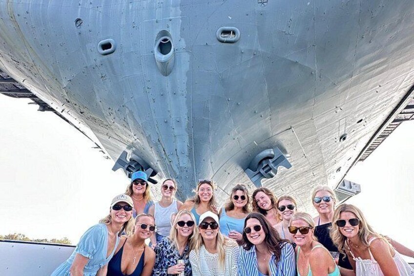 A group of people posing in front of a large aircraft. 5