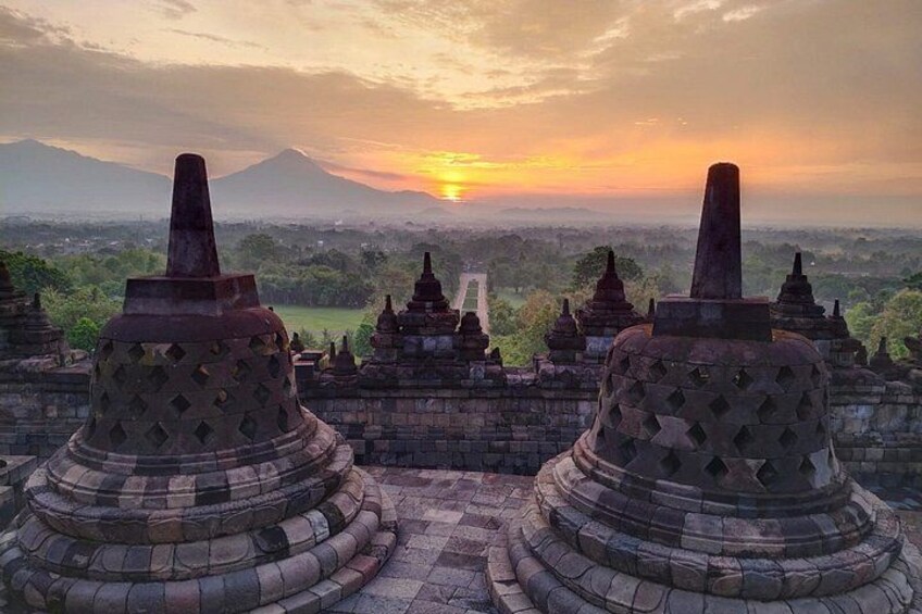 Temple structures with a mountain in the background during sunset. 5