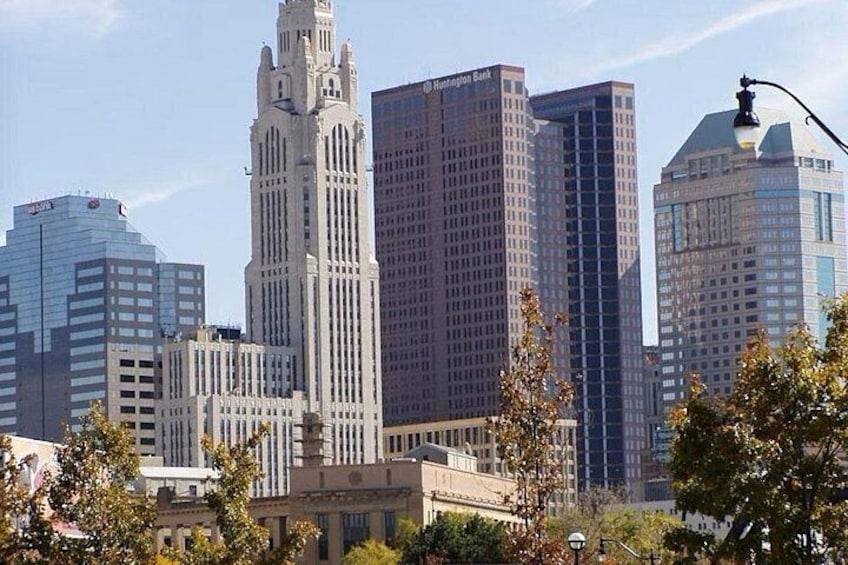 A city skyline with a prominent historic building and several modern skyscrapers. 2
