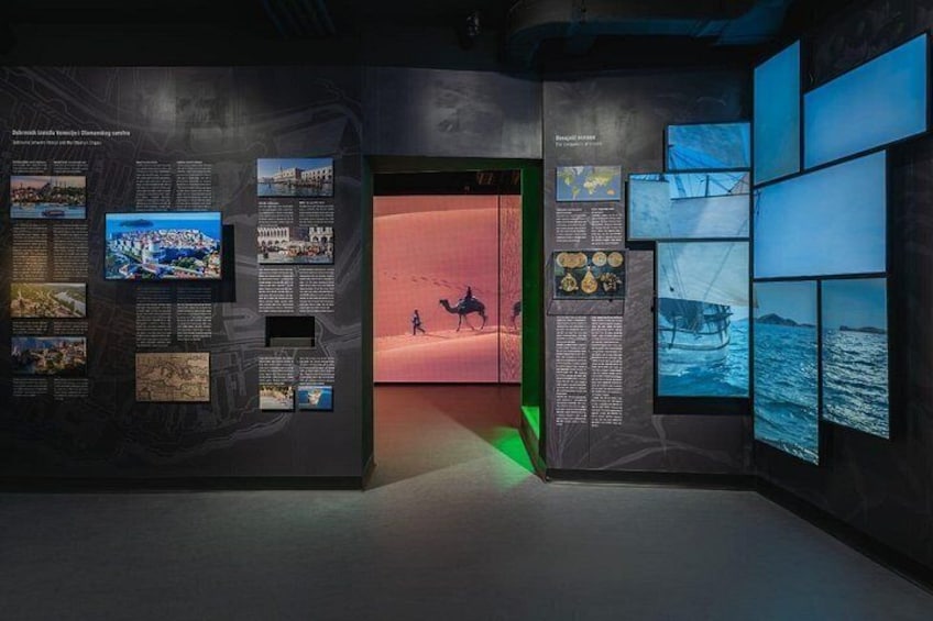 An exhibition with informational panels and digital displays. 4
