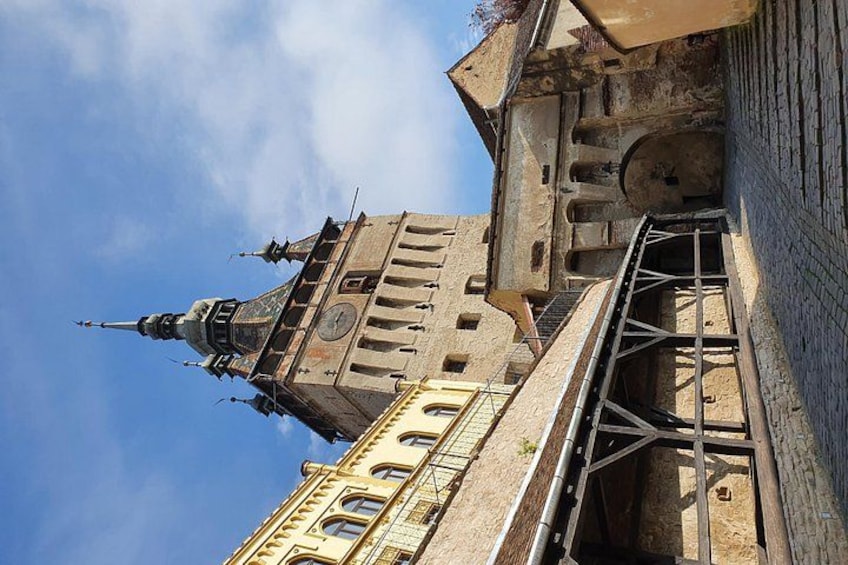 A historic building with a clock tower and scaffolding. 3