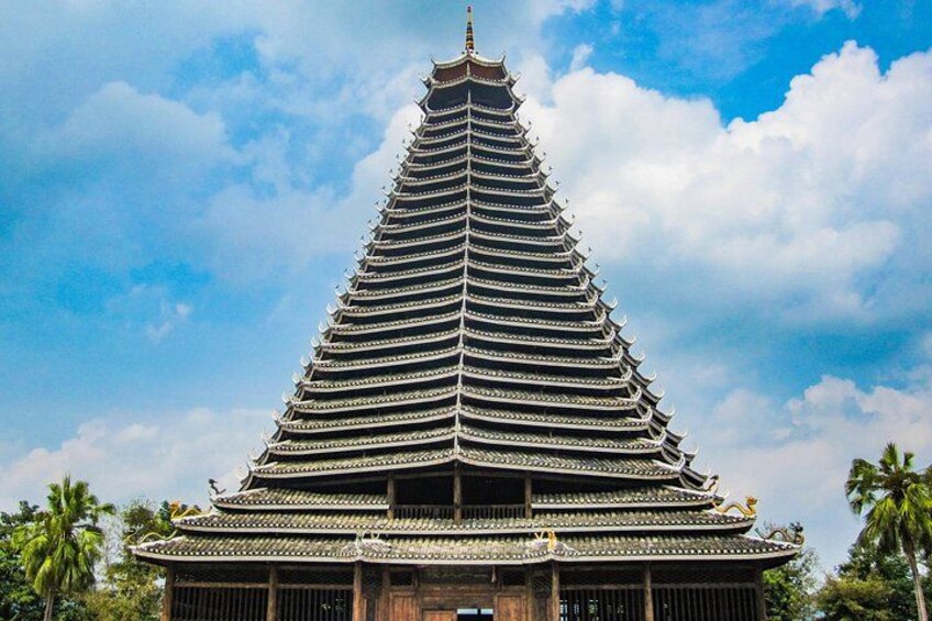 A traditional multi-tiered pagoda with ornate roof details, set against a clear sky. 4