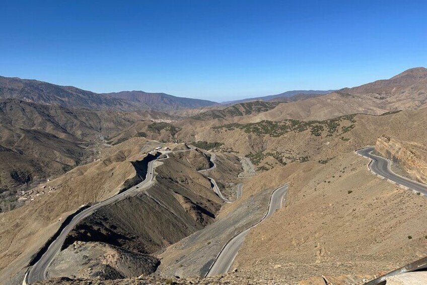 A winding mountain road in a dry, hilly landscape. 2