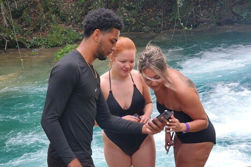 Three people standing by a river. 5