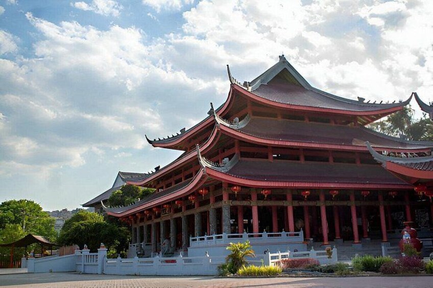 A traditional multi-tiered pagoda with red eaves and white railings. 4