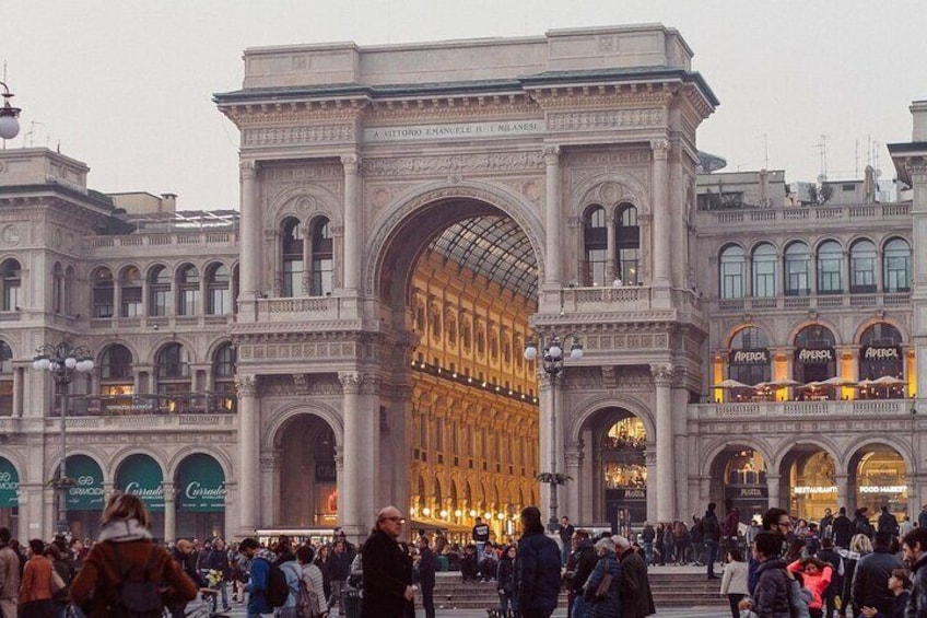 A large, ornate archway with shops on either side. 3