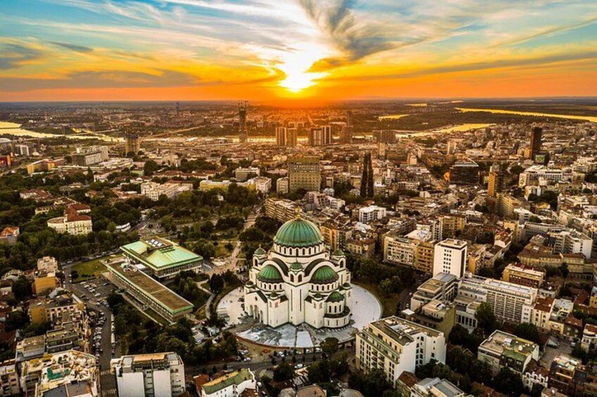 A cityscape with a prominent green-domed building surrounded by dense urban development. 5