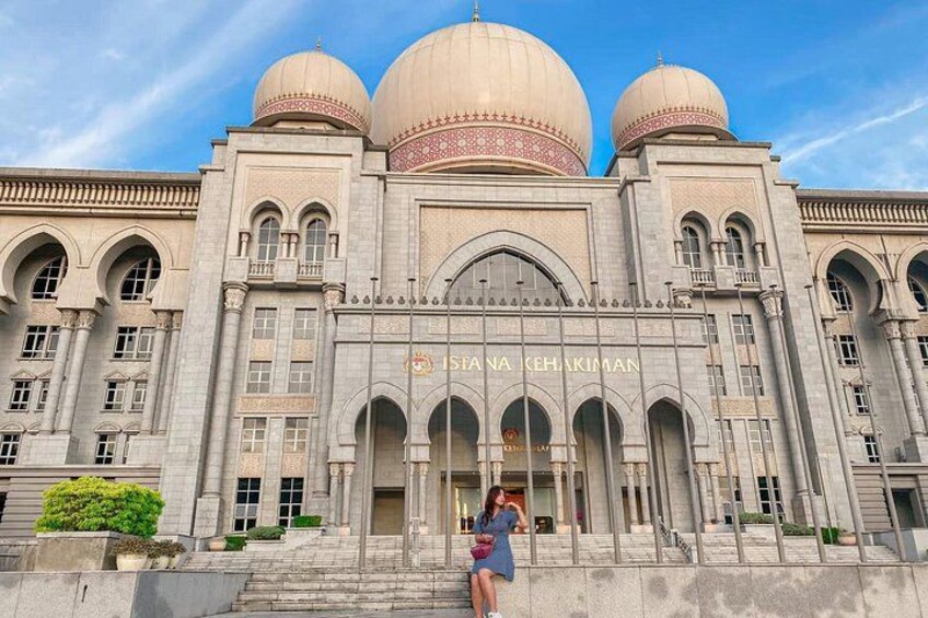 A large, historic building with three domes and arched windows. 5