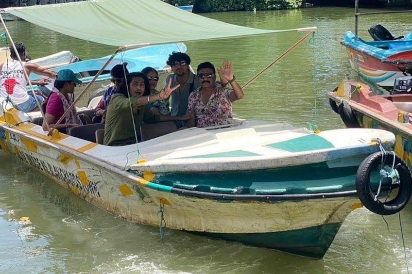 A small boat with people on it, docked at a calm water body. 3