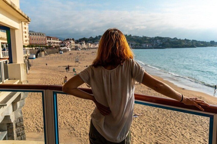 A person overlooking a beach with buildings in the background. 4