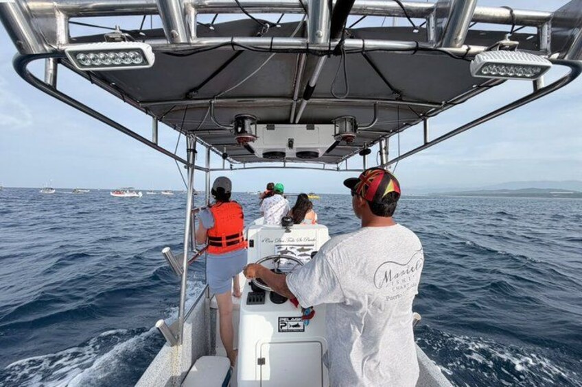 A boat with people wearing life jackets, moving on the ocean. 3