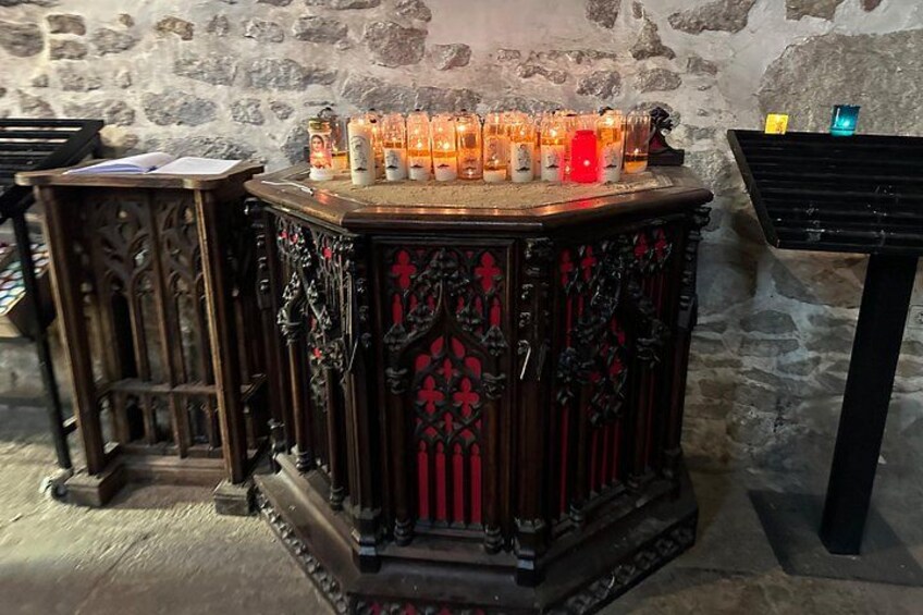 A wooden table with candles and a keyboard. 2