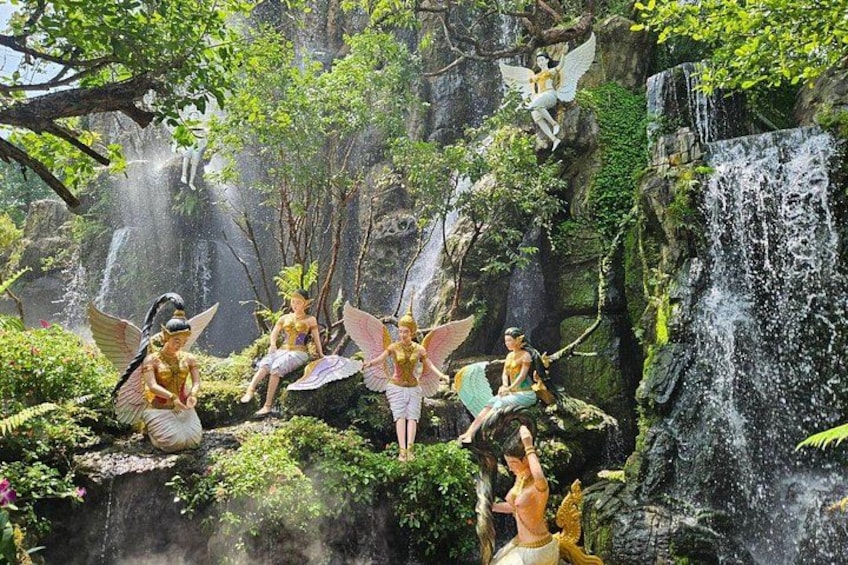 A waterfall with statues of winged figures. 5