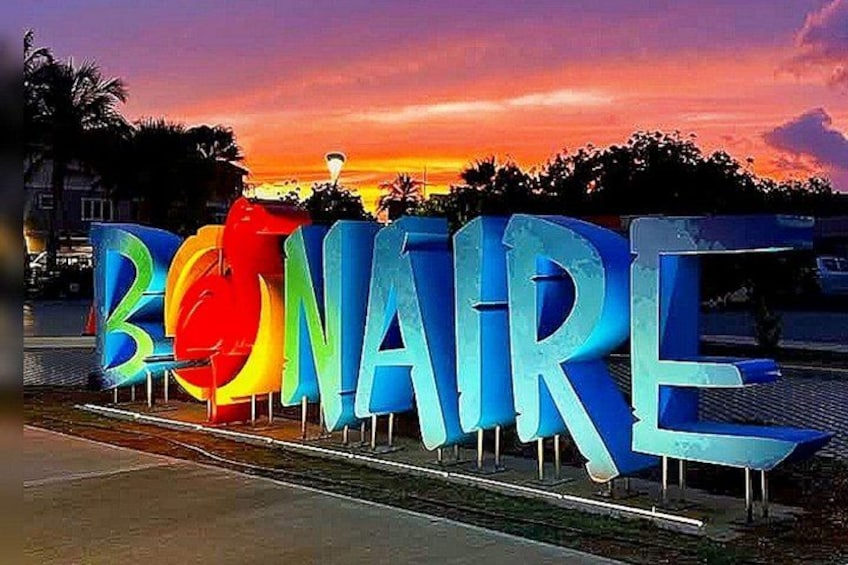 A large, colorful sign spelling 'BONAIRE' with a sunset in the background. 1