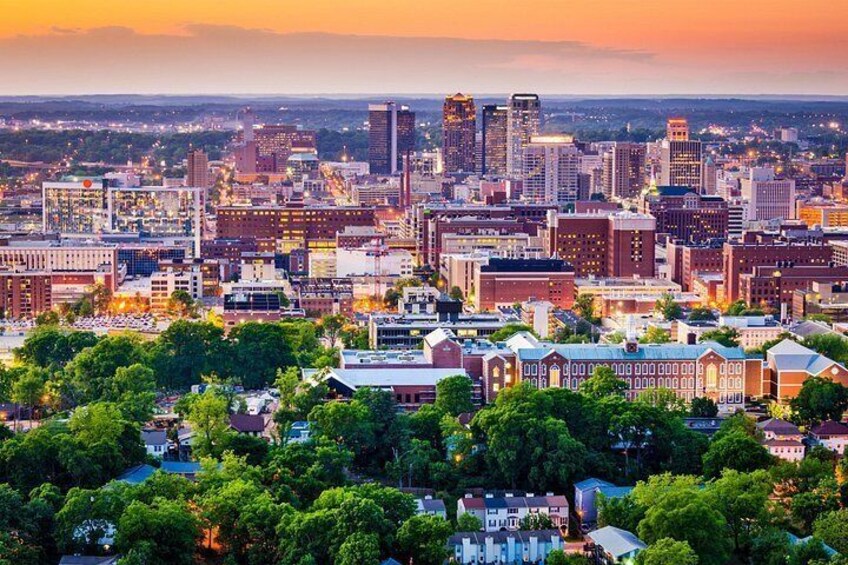A cityscape with a mix of modern and historic buildings, a river, and a sunset sky. 2