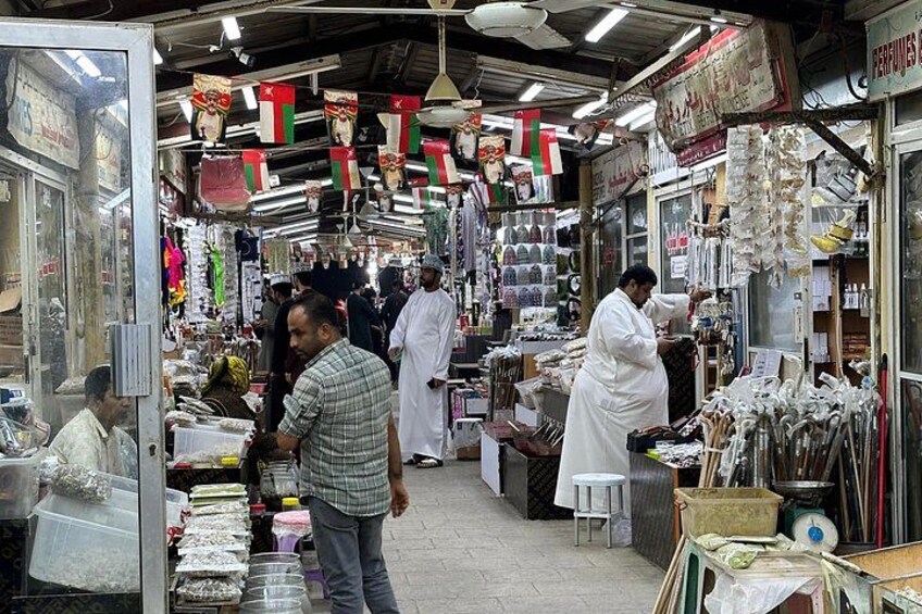 Un marché animé où l’on trouve de nombreux étals vendant toutes sortes de produits, notamment des chaussures et des articles ménagers. 4