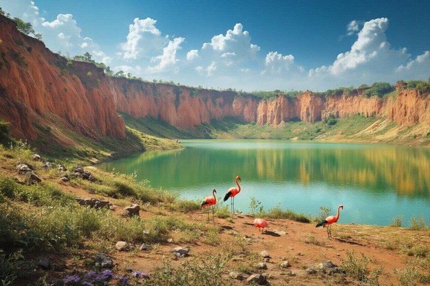 Un lac bordé de falaises rouges, un ciel dégagé et des flamants roses. 1