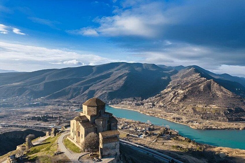 A mountainous landscape with a church and a river. 3