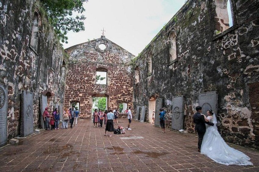 A historic building with a brick facade and arched windows, surrounded by a brick pathway. 4