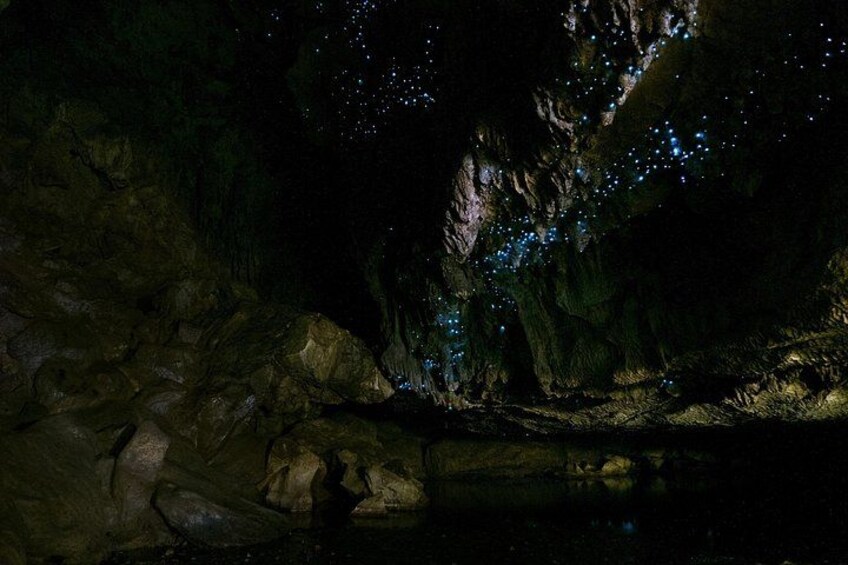 A cave with illuminated blue lights and a rocky terrain. 1