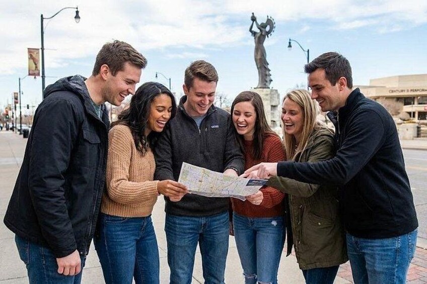 A group of people examining a map outdoors. 4