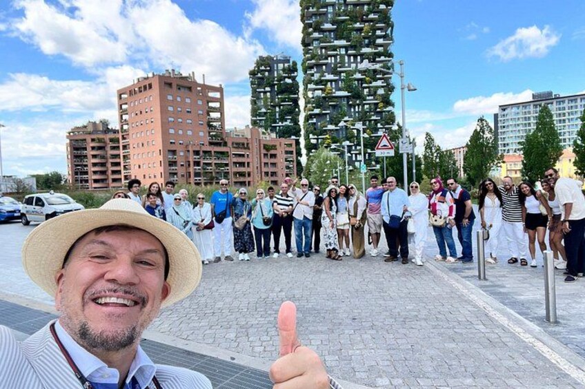 A group of people standing in a city square with modern buildings in the background. 5
