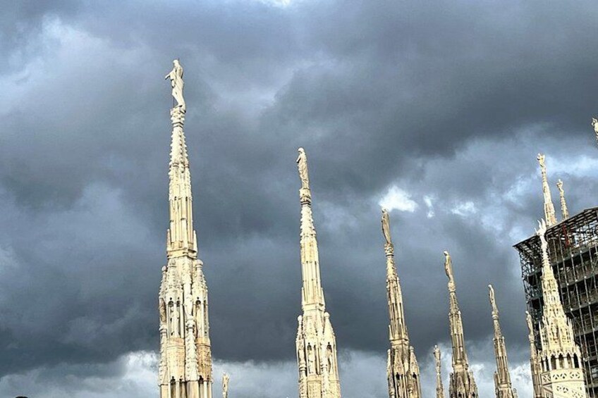 A Gothic cathedral with multiple spires and a cloudy sky. 2