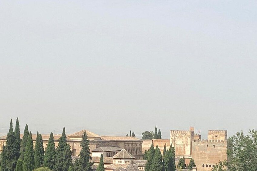 A historic building with a large dome and a castle in the background. 2