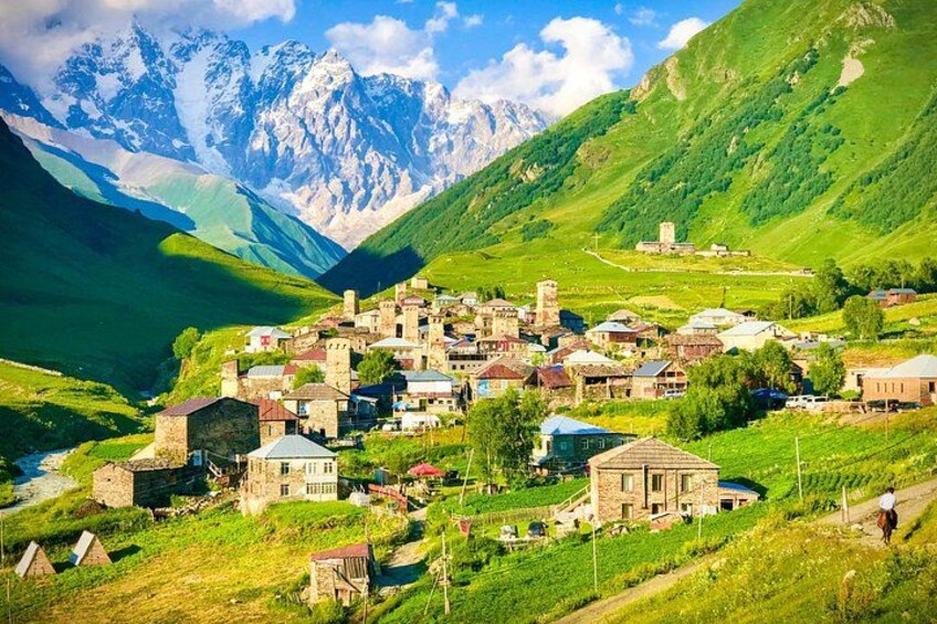 A village nestled in a valley with mountains in the background. 3