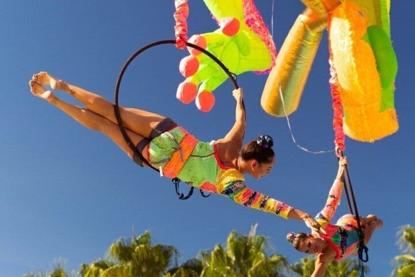 A person performing aerial acrobatics with colorful fabric. 2