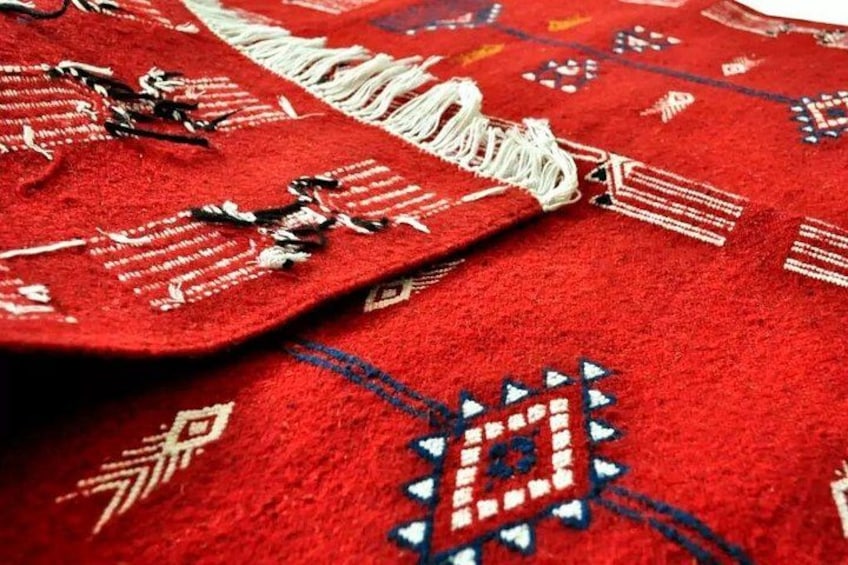 A red carpet with intricate patterns and fringes. 3