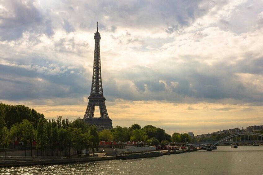 The Eiffel Tower, a river, and a bridge in the background. 2