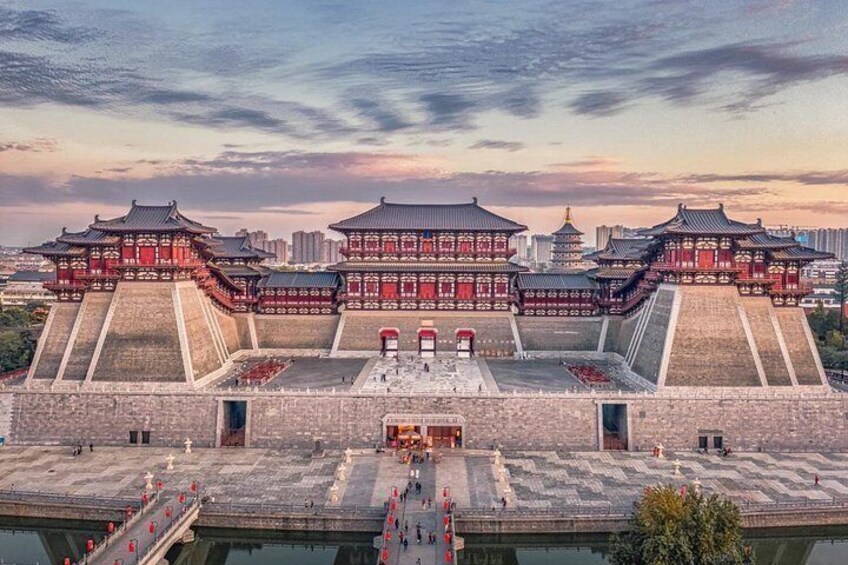A traditional Chinese architectural complex with multiple pagoda-style buildings and a large open courtyard. 2