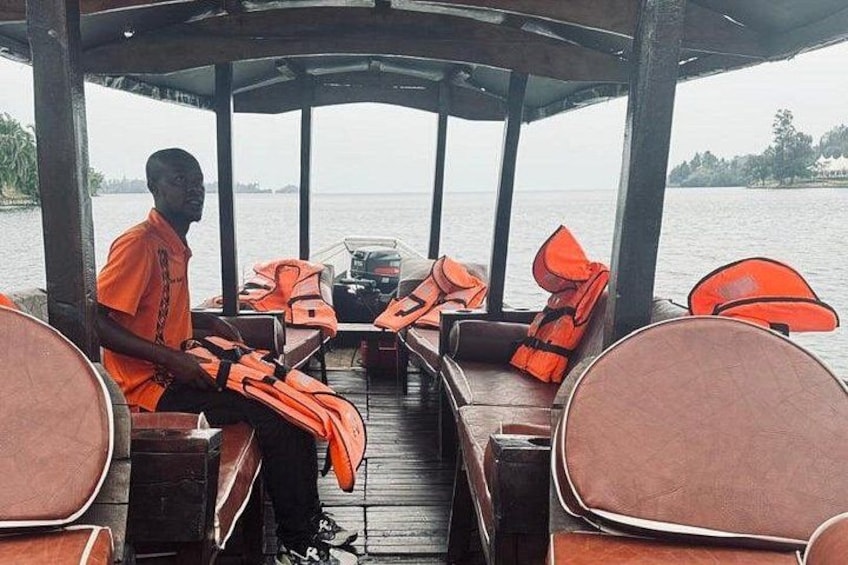 A boat with a covered seating area, life jackets, and a person seated. 3
