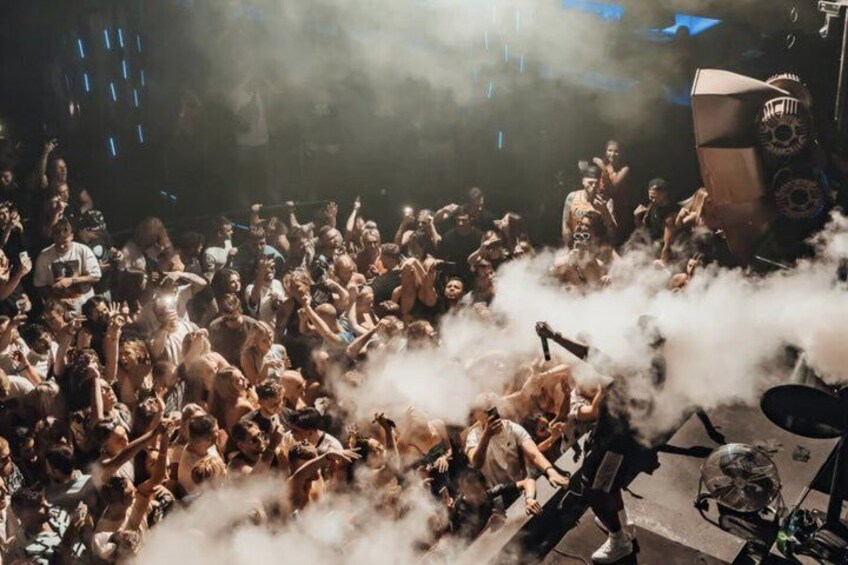 A crowded event with people and a stage. 2