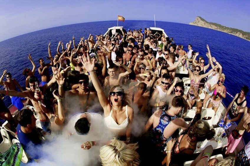 A group of people on a boat with raised hands, likely celebrating or enjoying a party. 1