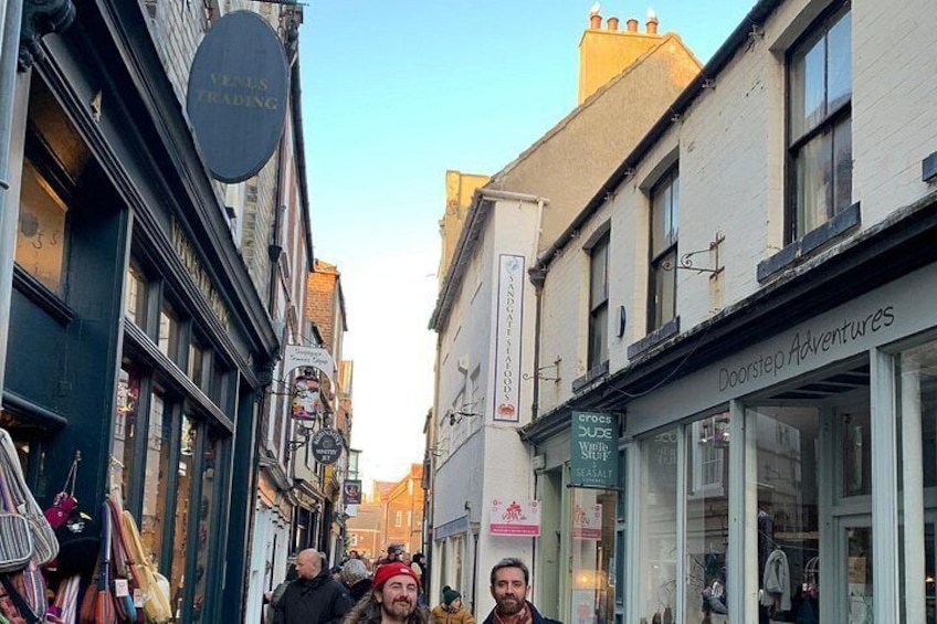 A narrow street with shops, including a visible sign for 'Venus Trading' and 'Doorstep Adventures'. 4