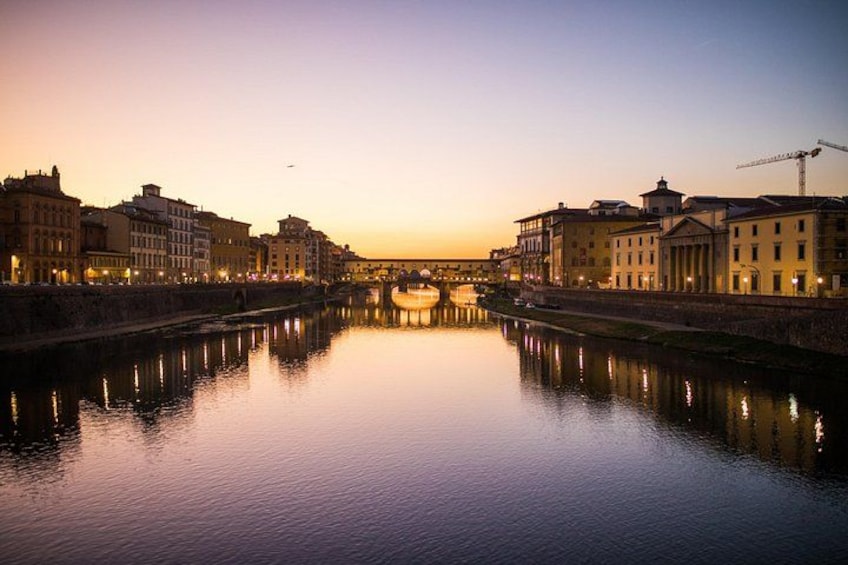 A calm river reflecting buildings at sunset. 3