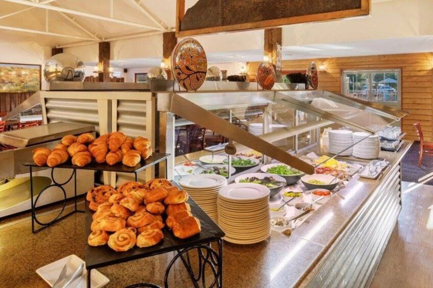 A buffet with various food items, including pastries and salads. 4