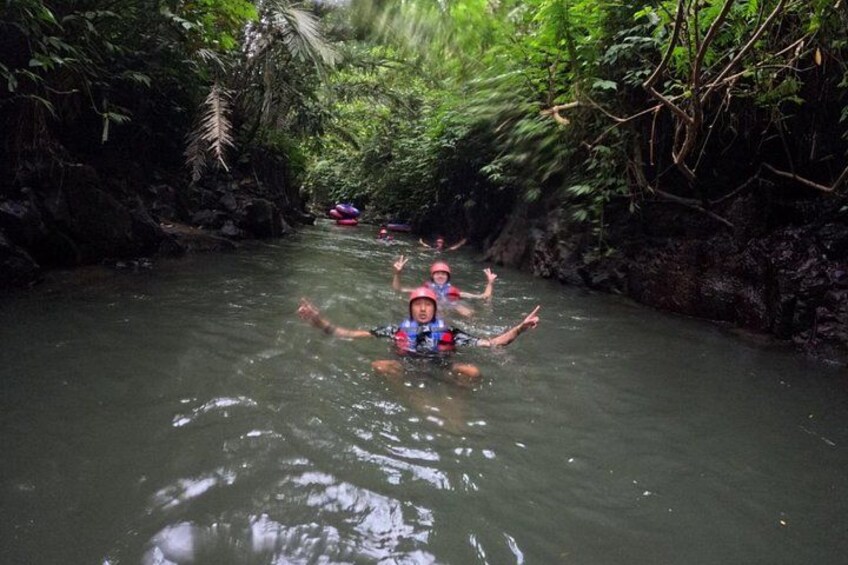 A river with people swimming and kayaking. 2