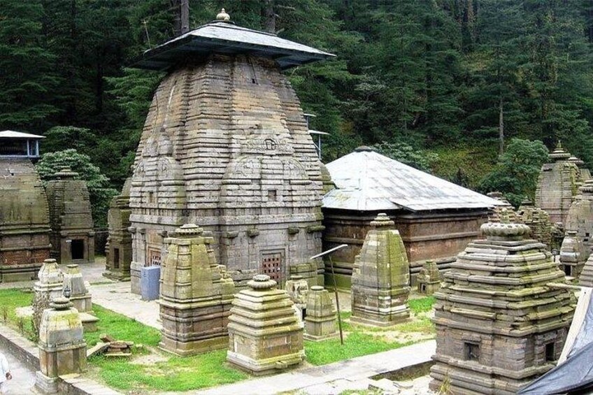 A temple complex with multiple stone structures, including a large central building and smaller surrounding shrines. 3